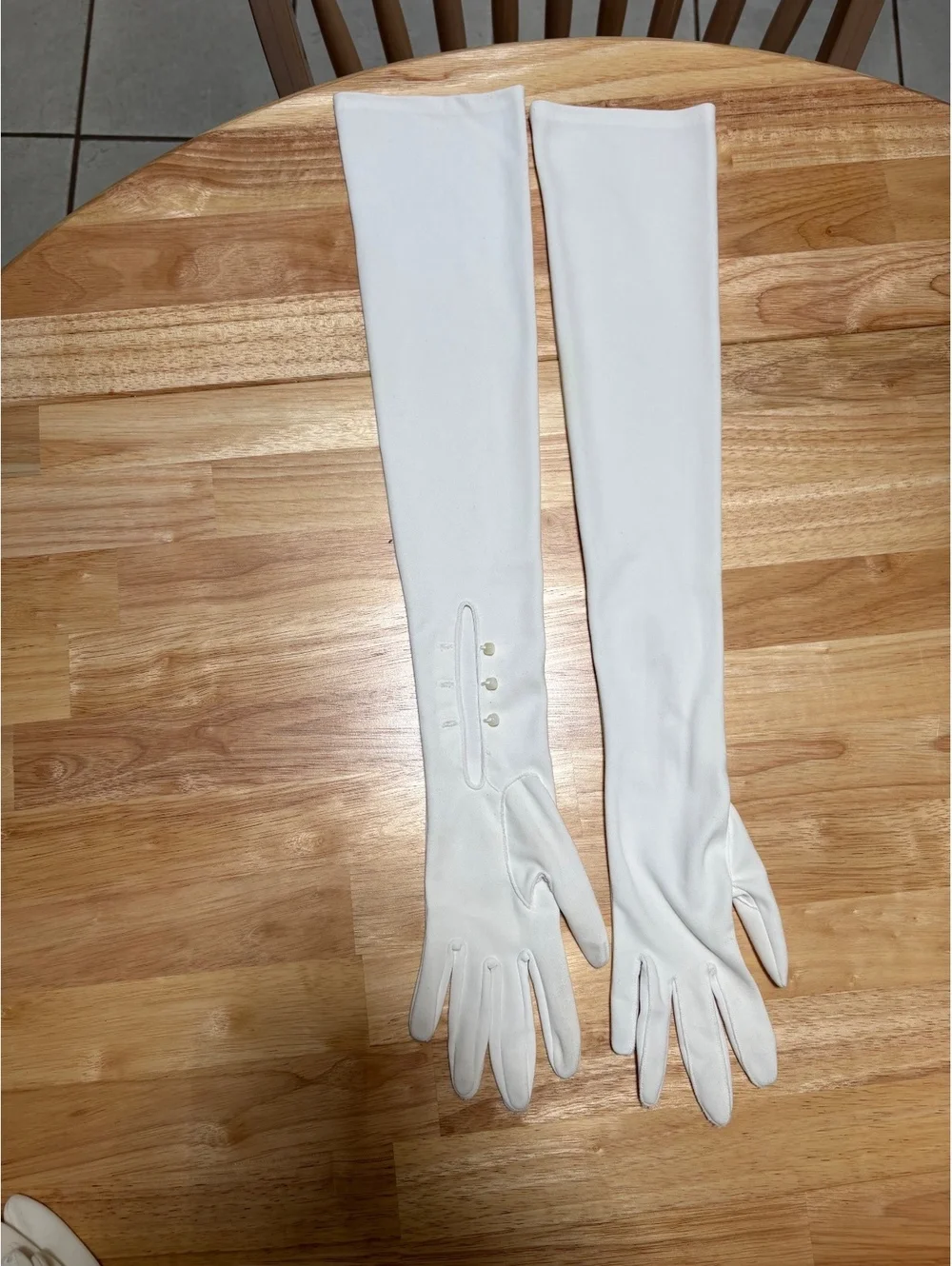 Five pairs of dress gloves. One pair of opera length gloves. Small size.